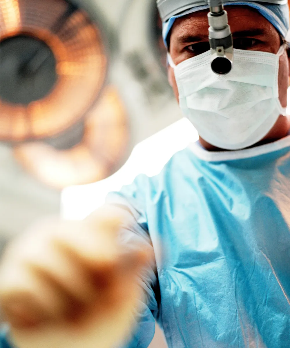 An oral surgery patient and surgeon reviewing a treatment plan in a bright, modern dental clinic